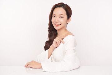 A beautiful young Asian woman with clean, fresh skin against a white background. Skincare, facial treatment, cosmetology, beauty, and spa. An elegant portrait of an Asian woman.