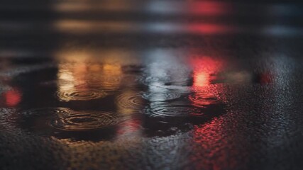 Colorful reflections of city night lights on a wet asphalt road with rain ripples - Powered by Adobe