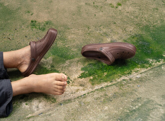 Senior man is fall because mossy on wet outdoor floor very slippery.