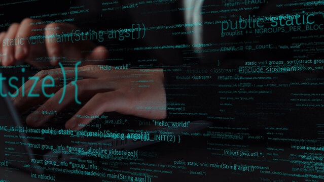 Close-up of hands typing on a keyboard with lines of code on screen, symbolizing the fusion of human creativity and technology in software development processes. Xenic