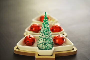 Christmas background. Dish in the shape of a Christmas tree with balls decorations on the table.