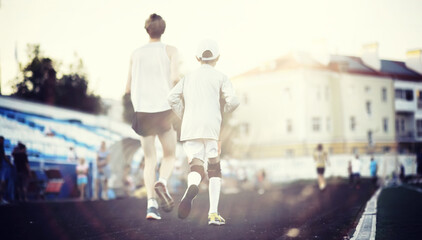 Sports in the stadium. Sports Equipment. Warming up the player before the game. Child Game.