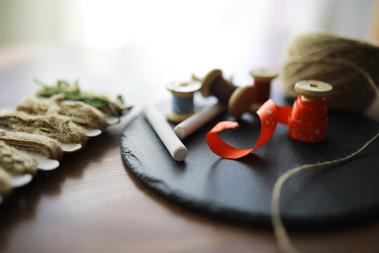 Old scissors, spools of colored thread, centimeter and tailors chalk, flat lay, concept of sewing clothes