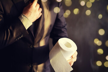 Businessman Holding a pile of Toilet Paper, copy space. Toilet papers is the new currency concept.