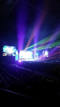 Epic Stage Light Show with green screen chroma key model released back view of huge crowd dancing and cheering at a concert or shot on red helium 8k in raw distortion, overlay, glitch, static noise