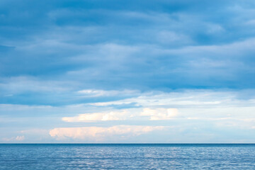 Obraz premium Aerial view of a background image for a summer vacation concept. Nature, beach and sea, sunny summer, sparkling seawater contrasting with a blue sky.