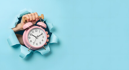 Hand holding alarm clock, torn paper hole, time management, reminder and planning, finish a deadline, timetable and stress, countdown