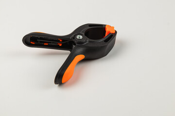 Versatile black and orange clamp tool for various projects