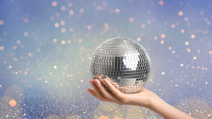 Hand holding disco ball with sparkling lights, created AI