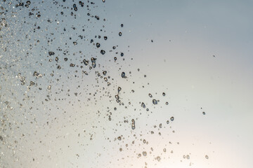 Splashes and jets of water against light background.