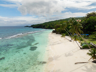 Transparent clear ocean waves over the white sandy beaches in Carabao Island, Romblon, Philippines.
