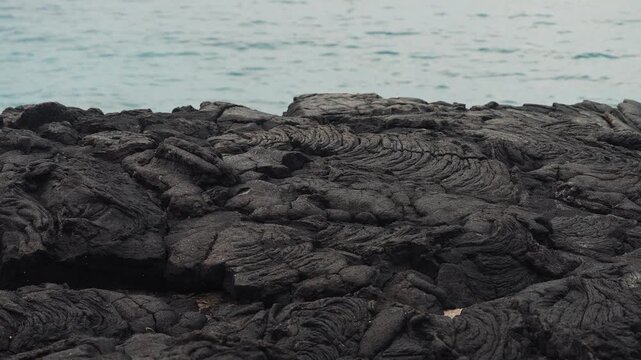 Beautiful molten volcanic rock hardened next to ocean in Hawaii (4k60p)