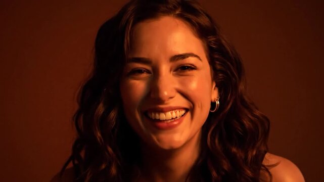 Smiling woman with wavy hair in warm lighting