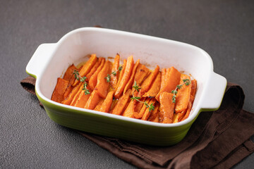 Baked sweet potatoes white thyme in a baking dish
