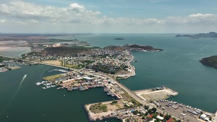 Drone flying backwards over the Topolobampo village, sunny day in Sinaloa, Mexico