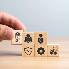 Safety blocks. Hand adding safety icon on a wood block stack