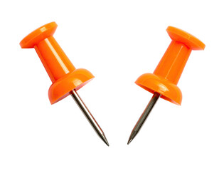 Two vibrant orange pushpins against a stark black background, angled and sharp
