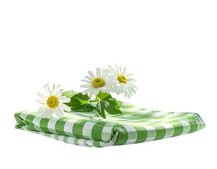 Three white daisies on a folded green and white checkered cloth, isolated, black background