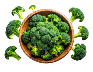 Fresh green broccoli florets spilling from a wooden bowl against a black backdrop