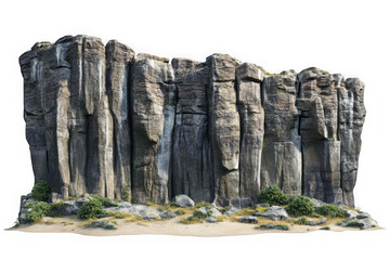 Tall grey columnar rock formations with green vegetation on sandy ground cliff mountain