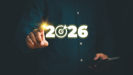 Business vision and goal concept for year 2026 showing person pointing at glowing number 2026 with target icon, representing future planning, achievement, and strategic success.