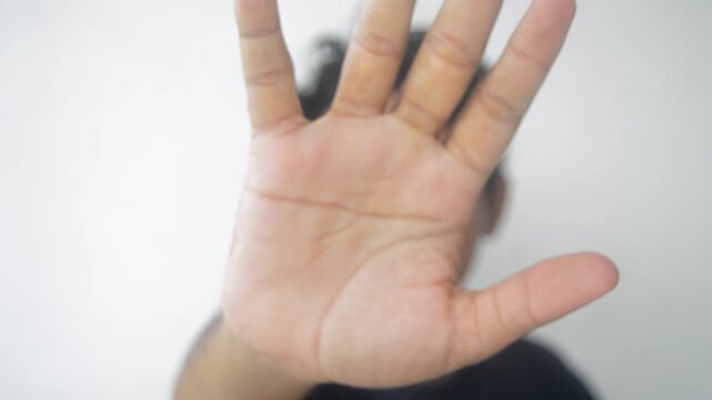 Footage shows a man gesturing with his hand in a sequence of frames, moving it closer to the camera in a stop motion style against a neutral background for various concepts.