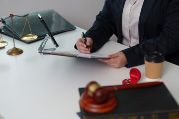 Legal Professional Signing Documents at Office Desk