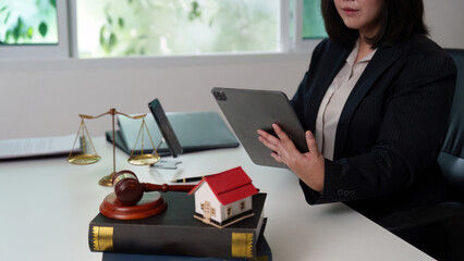 Legal Professional Using Tablet While Reviewing Documents
