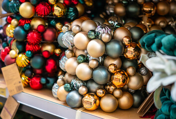 Christmas baubles displayed in store. Different colors and sizes. Tree decorations. Holiday season, home décor, preparation for Christmas celebrations.