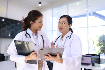 Two medical doctors woman checking the patient papers in  hospital, Medical technology and Healthcare concept. 