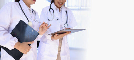 Two medical doctors woman checking the patient papers in  hospital, Medical technology and Healthcare concept. 