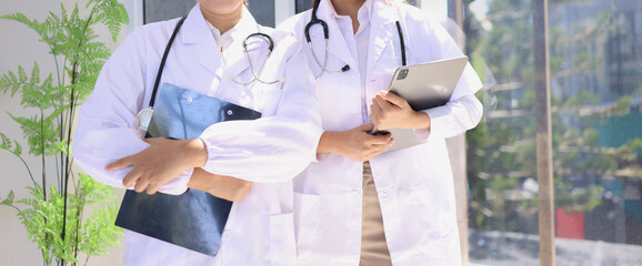 Two medical doctors woman checking the patient papers in  hospital, Medical technology and Healthcare concept. 