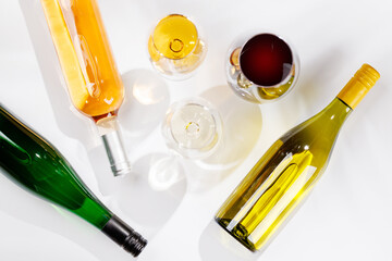 Fototapeta premium Different wine bottles and glasses on white background