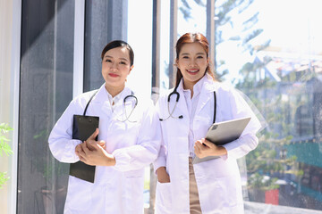 Two medical doctors woman checking the patient papers in  hospital, Medical technology and Healthcare concept. 