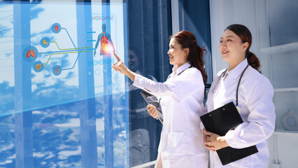 Two professional female doctor working with human anatomy virtual interface icons. Medical technology and Healthcare concept. 