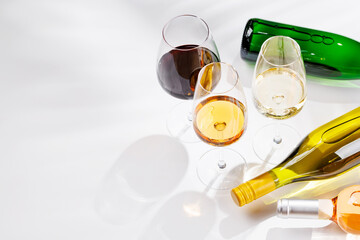 Fototapeta premium Different wine bottles and glasses on white background