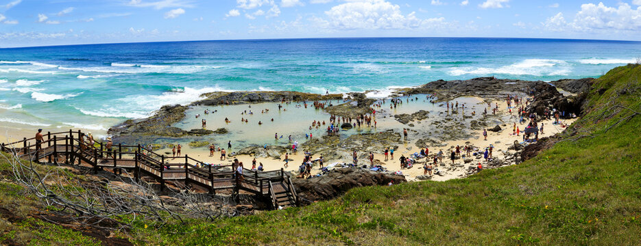 Hordes of people enjoying swimming in Champagne Pools on K'gari Fraser Island, QLD