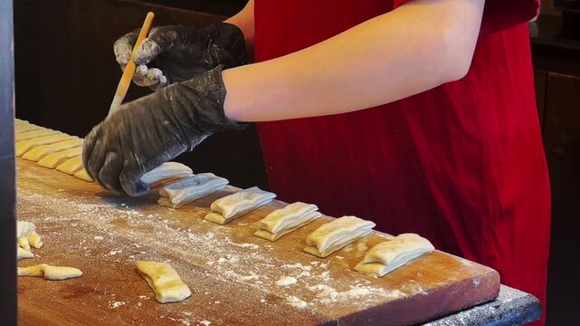  Chef is shaping dough sticks prepare to fry in hot oil.,Making Deep fried dough stick at street food breakfast is famous for backpacker and local and tourist at Chiang Mai Thailand.