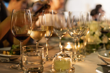 Red and white wine glasses on a beautifully set table, Fine dining and wine, Luxury table setting.