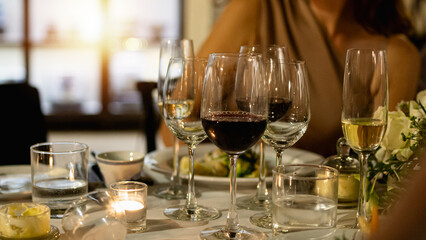 Red and white wine glasses on a beautifully set table, Fine dining and wine, Luxury table setting.