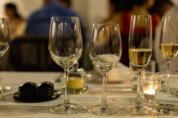 Red and white wine glasses on a beautifully set table, Fine dining and wine, Luxury table setting.