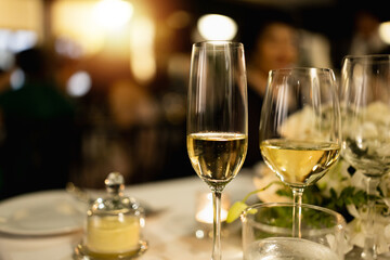Red and white wine glasses on a beautifully set table, Fine dining and wine, Luxury table setting.