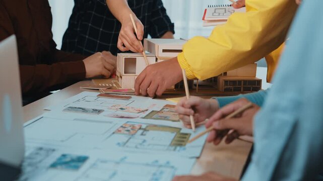 A dynamic scene inside a modern office where architects and designers collaborate on an urban development project, surrounded by plans and models showcasing their creative process. SACTR