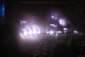 Crowd at concert and blurred stage lights.