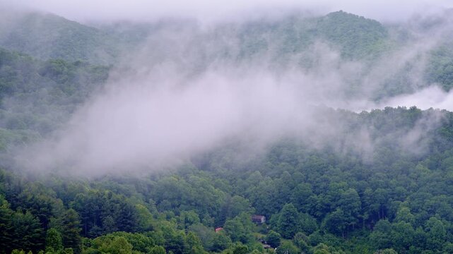 Drone footage sweeping along a mist-curled valley in the Smoky Mountains.