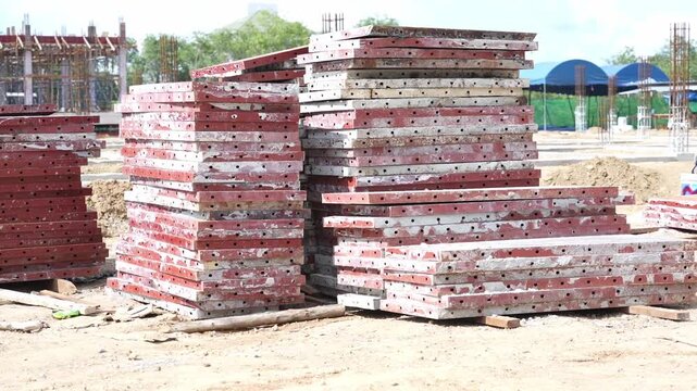 Stacked Metal Formwork Panel Construction Site Outdoor Industrial Steel Red Equipment Building Foundation Preparation Structure Material Development Organized Engineering Weathered Concrete Structure