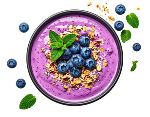 Overhead shot of a vibrant smoothie bowl with blueberries, mint, and granola