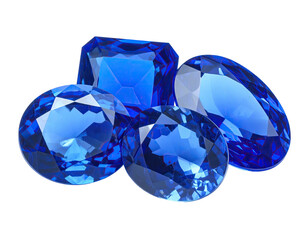 Group of faceted, vibrant, blue gems sparkle with reflections against black