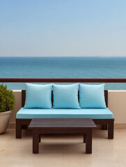 Obraz premium Cozy outdoor seating area overlooking a tranquil ocean on a sunny day