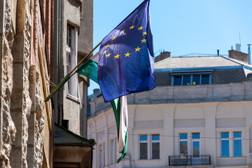 European Union and Hungarian flags on building wall